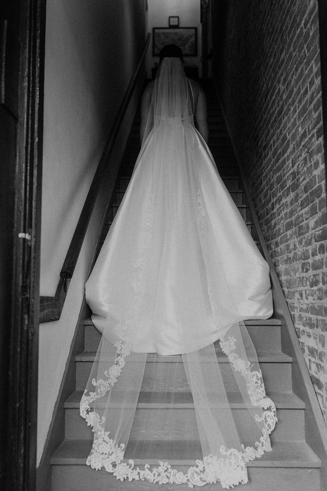 Bride on the staircase with gown trailing down